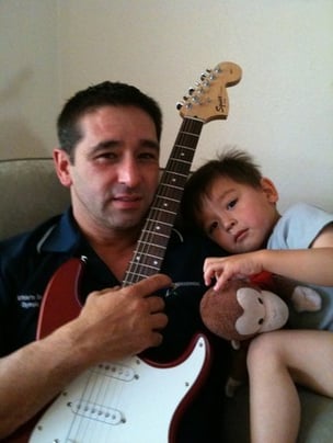Monkeying around with his guitar and son